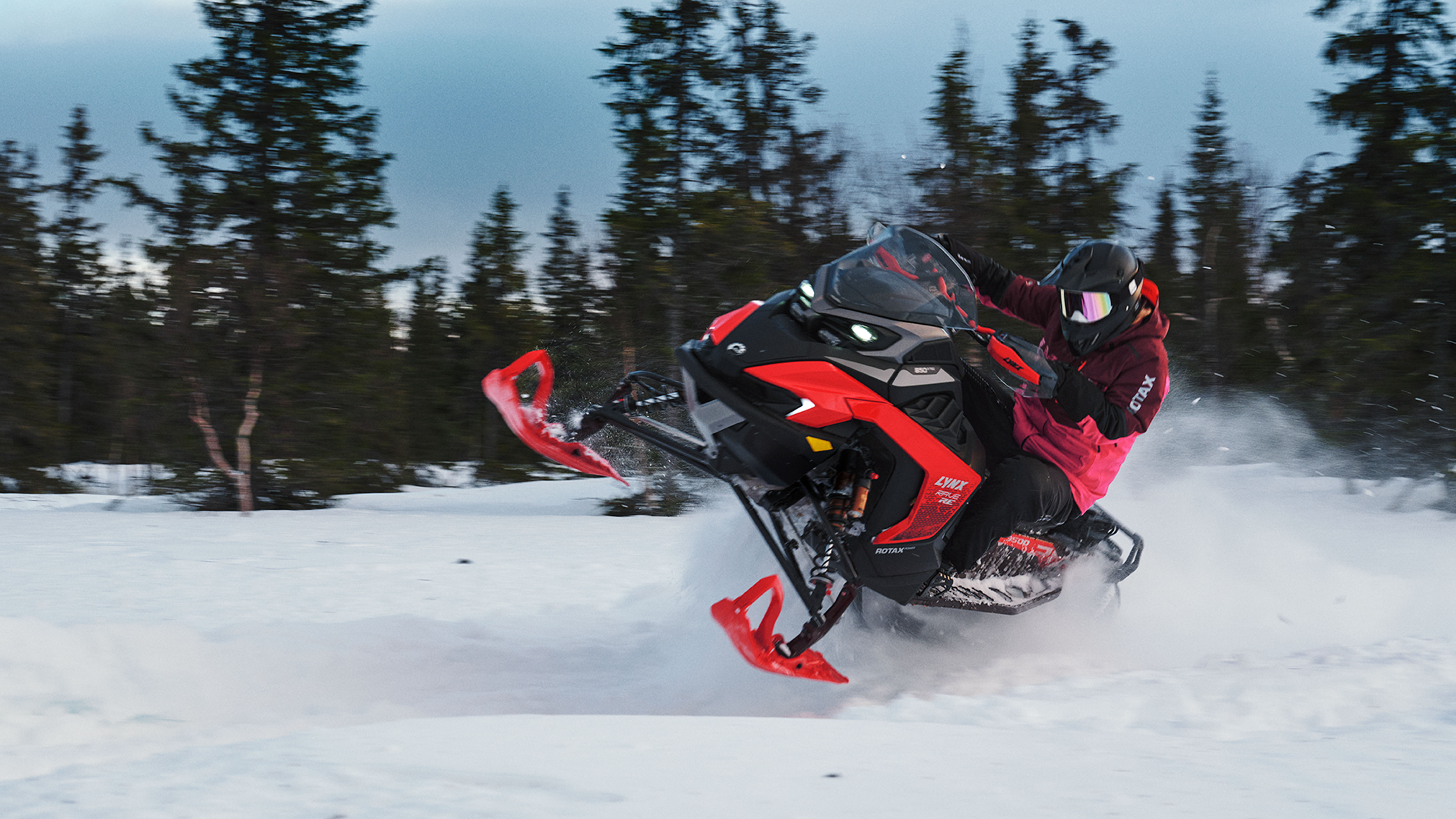 Lynx Rave RE 2025 snowmobile accelerating on snowy trail