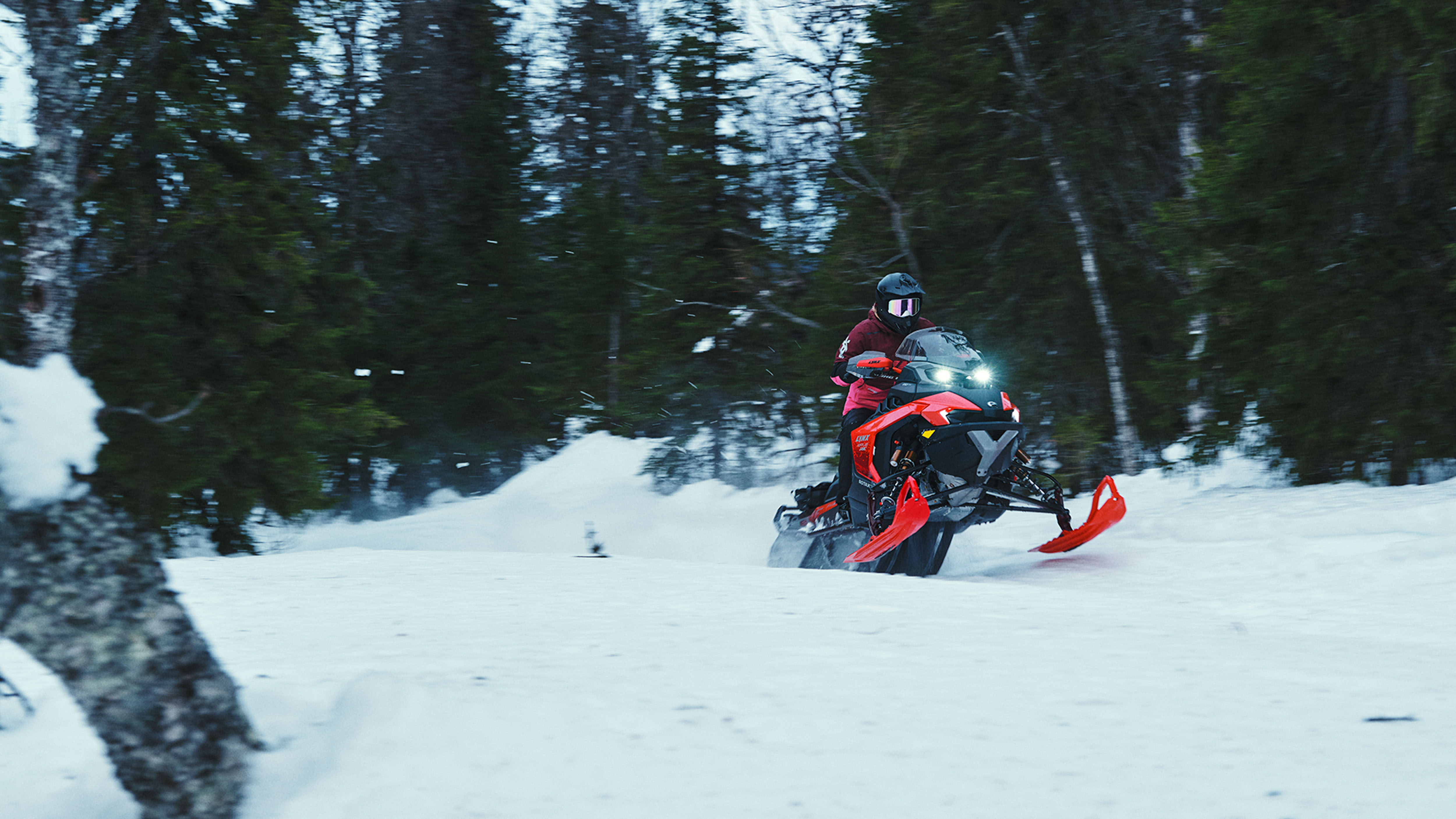 Lynx Rave RE 2025 snowmobile accelerating on trail
