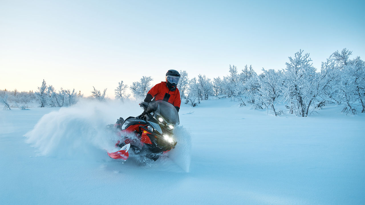 Rider riding through deep snow on a 2027 Lynx Brutal RE snowmobile